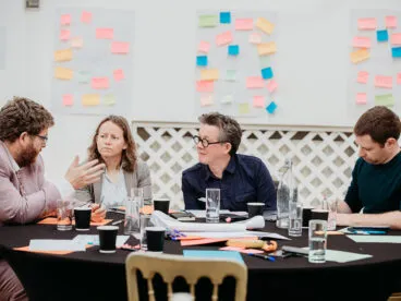 A group of people at a table having a discussion