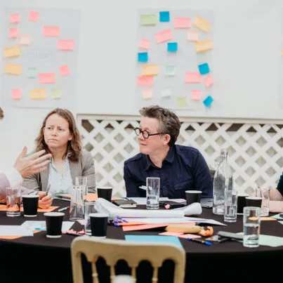 A group of people at a table having a discussion
