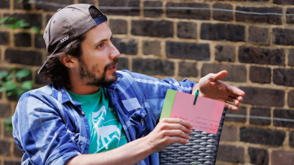 A participant sitting talking at an SSE learning session